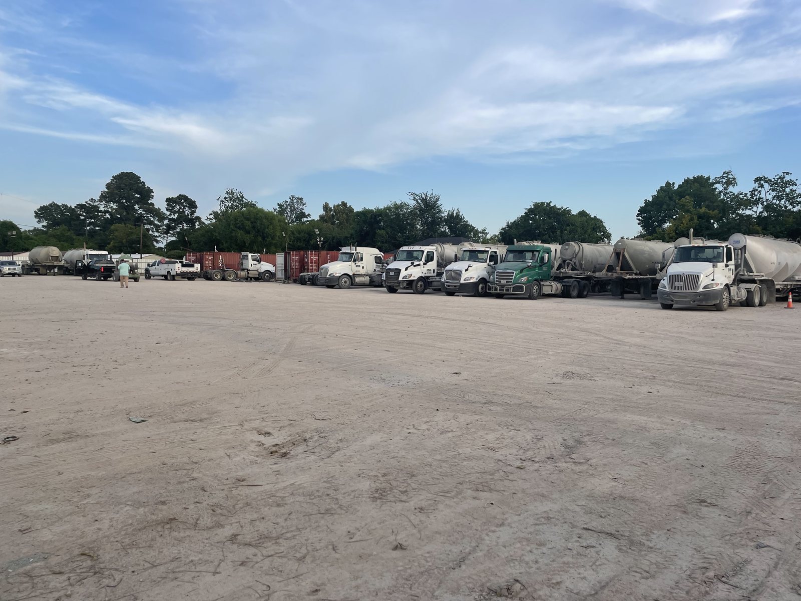 Tractors and pneumatic cement tankers parked at the Eazy Trans yard in Houston, Texas