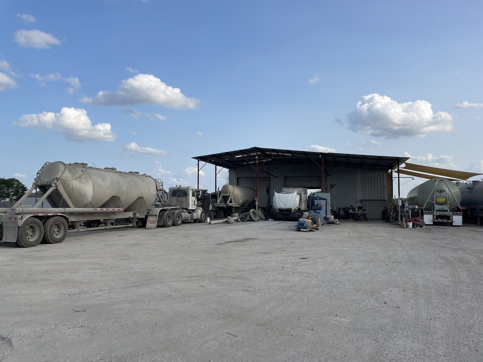 Tractor and pneumatic tankers staged outside the Eazy Trans maintenance shop