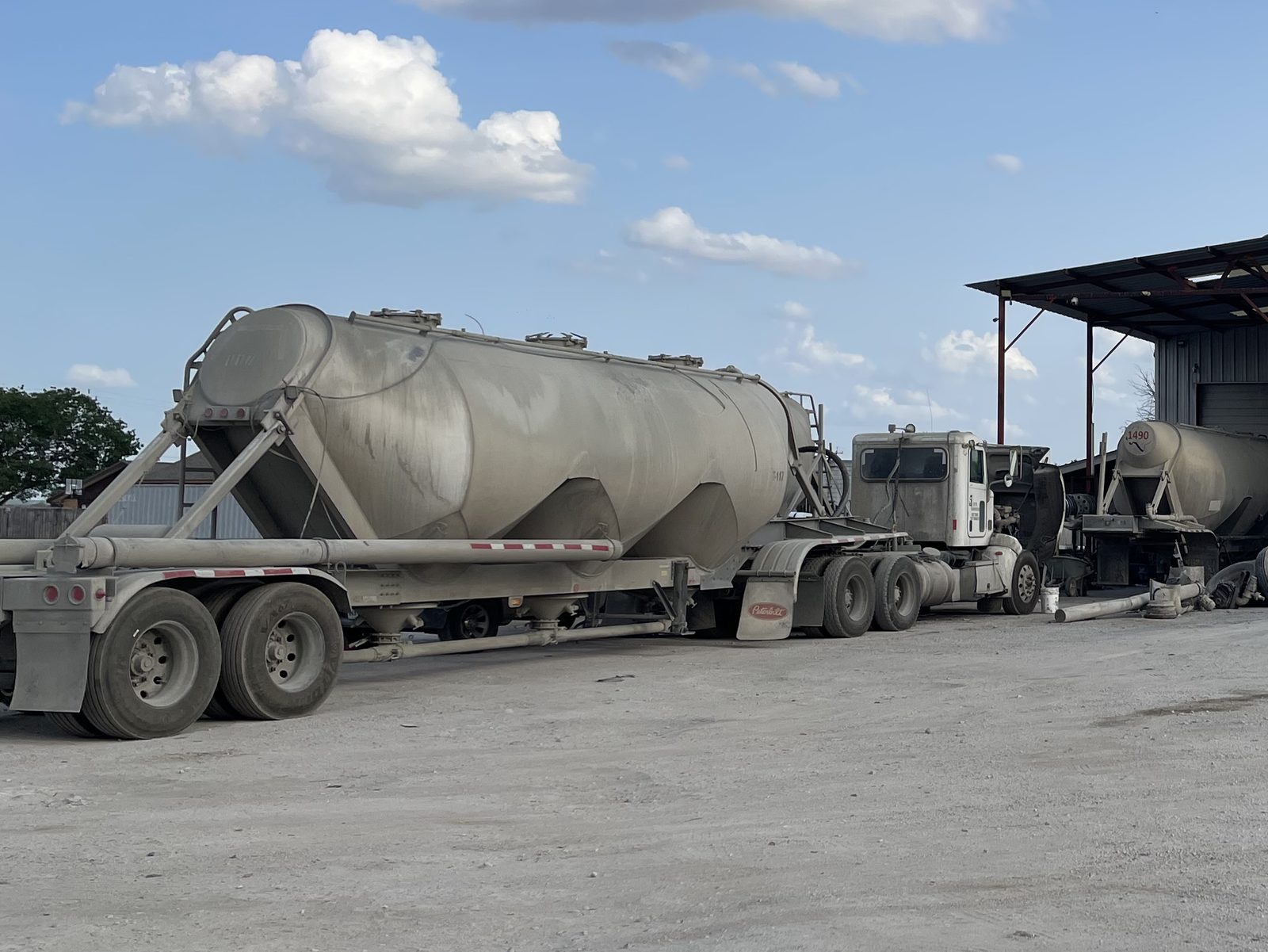Owner-operator tractor coupled to a pneumatic cement tanker at the Eazy Trans yard